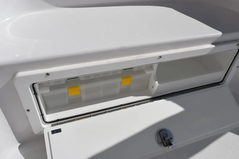 Slide: The Image of Storage compartment on 2026 Sea Hunt BX 25 FS boat, featuring secure latch and organized interior. - 20