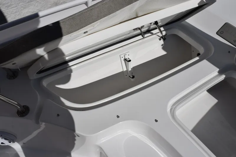 Slide: The Image of 2026 Sea Hunt BX 25 FS boat storage compartment with open lid, showcasing interior space. - 23