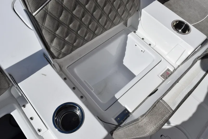 Slide: The Image of 2026 Sea Hunt BX 25 FS boat interior with storage compartment and cup holder. - 26