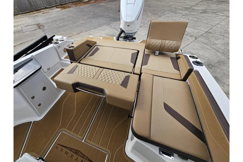 Slide: The Image of Luxury seating on 2026 Monterey Elite 27 OB boat, featuring tan upholstery and modern design. - 10