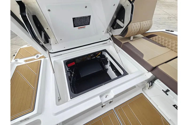 Slide: The Image of Open engine compartment of 2026 Monterey Elite 27 OB boat with seating and storage. - 12