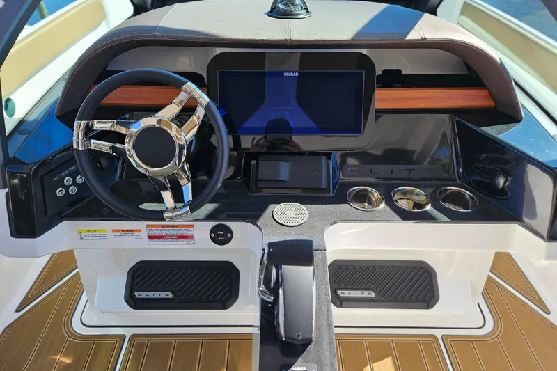 Slide: The Image of 2026 Monterey Elite 27 OB boat dashboard with modern steering and digital display. - 17