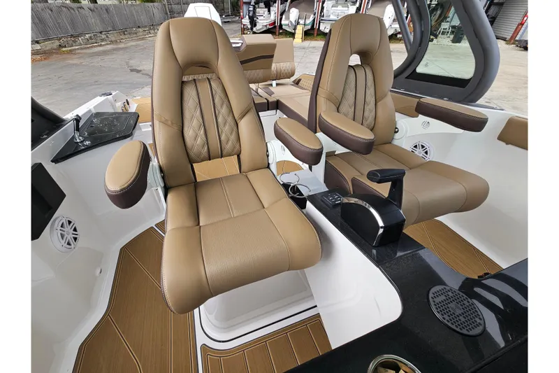 Slide: The Image of Luxurious interior of 2026 Monterey Elite 27 OB boat with tan leather seats and modern controls. - 18