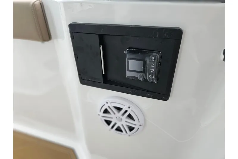 Slide: The Image of 2026 Monterey Elite 27 OB boat control panel and speaker detail. - 24
