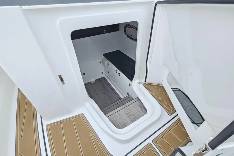 Slide: The Image of Interior cabin of 2026 Monterey Elite 27 OB boat with wooden flooring. - 26