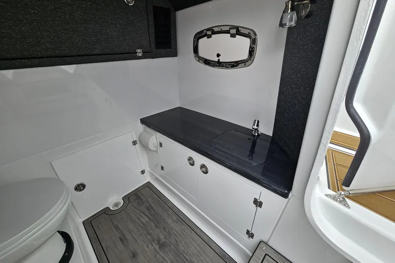 Slide: The Image of 2026 Monterey Elite 27 OB boat bathroom with sleek design and modern fixtures. - 27