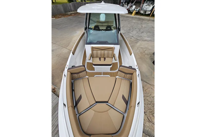 Slide: The Image of 2026 Monterey Elite 27 OB boat with luxurious tan seating and sleek design. - 31
