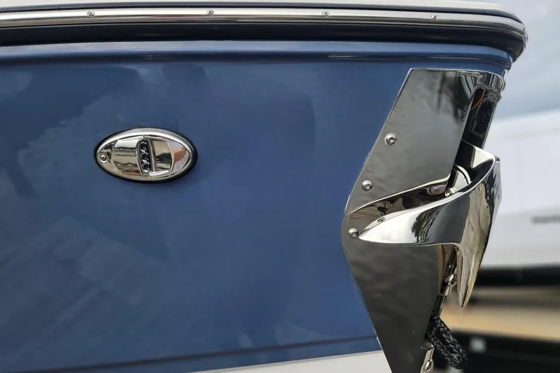 Slide: The Image of 2026 Monterey Elite 27 OB boat, blue hull with chrome detailing, close-up view. - 38