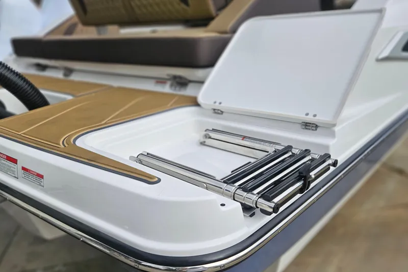 Slide: The Image of 2026 Monterey Elite 27 OB boat with foldable swim ladder and sleek deck design. - 40