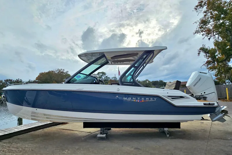 Slide: The Image of 2026 Monterey Elite 27 OB boat on display, featuring sleek design and modern outboard motor. - 6
