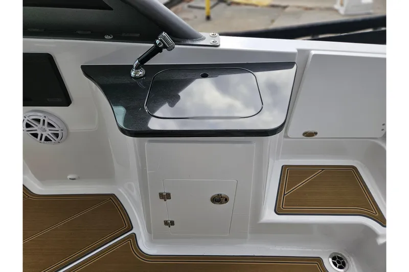 Slide: The Image of 2026 Monterey Elite 27 OB boat interior with sleek sink and wood-accented flooring. - 8