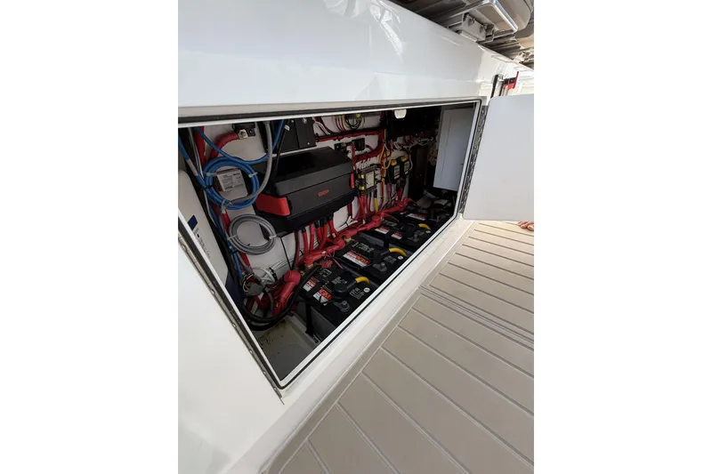Slide: The Image of 2024 Bertram 39 CC electrical compartment with batteries and wiring. - 16