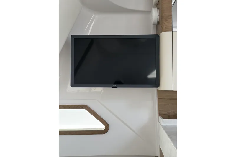 Slide: The Image of Flat-screen TV mounted in 2024 Bertram 39 CC boat interior. - 19
