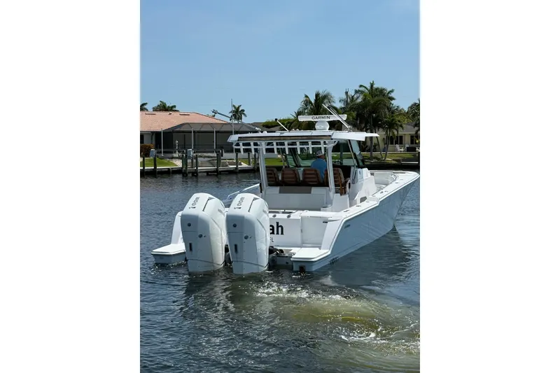 Slide: The Image of 2024 Bertram 39 CC boat with dual engines on a sunny day. - 2
