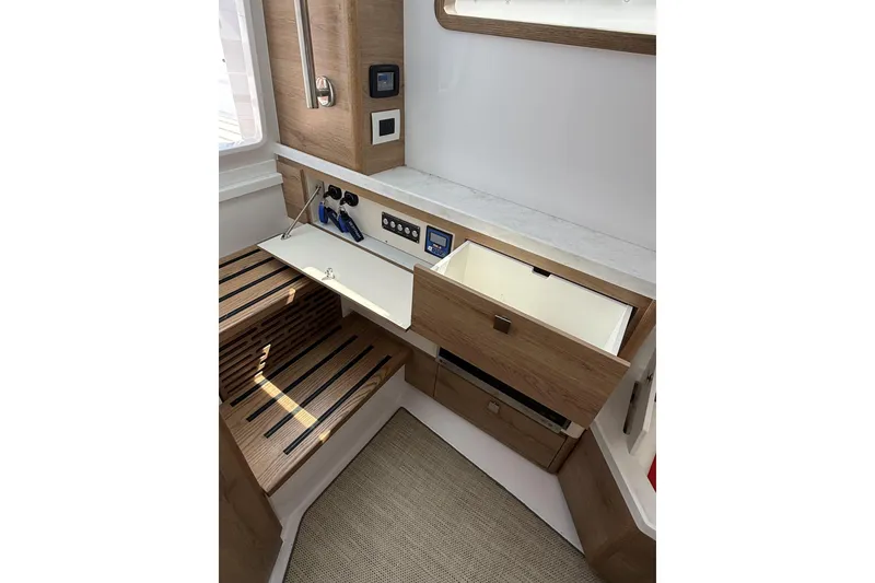 Slide: The Image of 2024 Bertram 39 CC interior with wooden cabinetry, open drawers, and modern controls. - 20