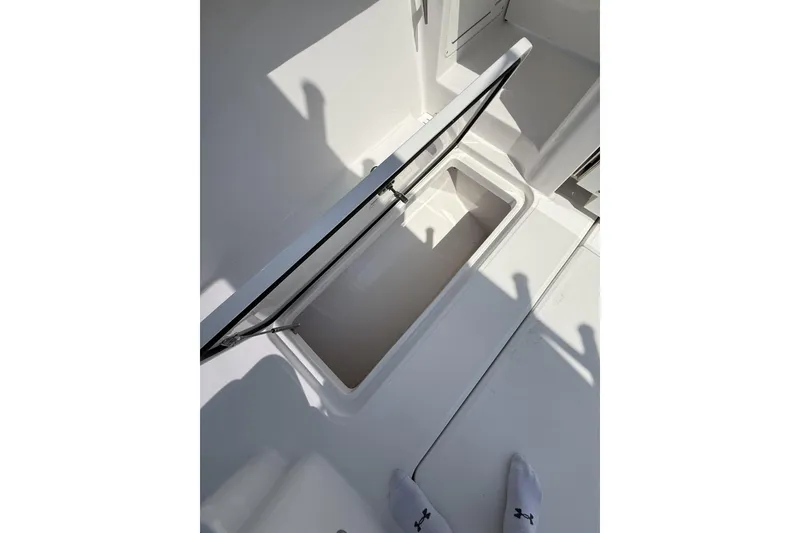 Slide: The Image of 2024 Bertram 39 CC boat storage compartment with open lid, showcasing interior space. - 31