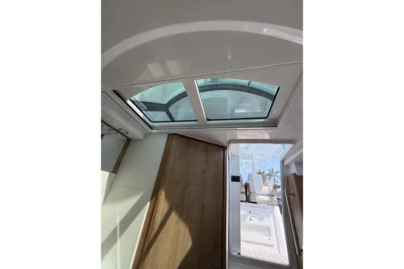 Slide: The Image of Interior view of 2024 Bertram 39 CC boat with skylight and wooden accents. - 34