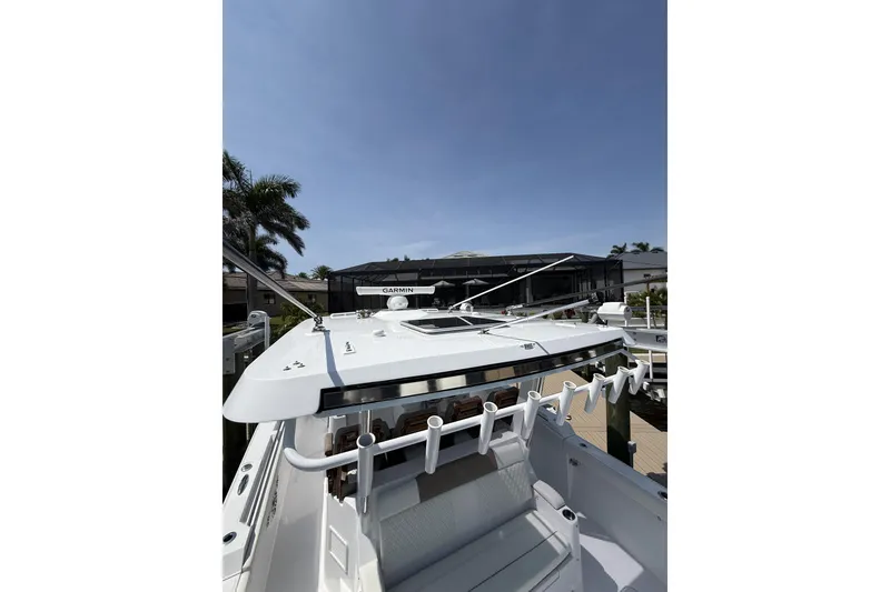 Slide: The Image of 2024 Bertram 39 CC boat docked under clear blue sky. - 39