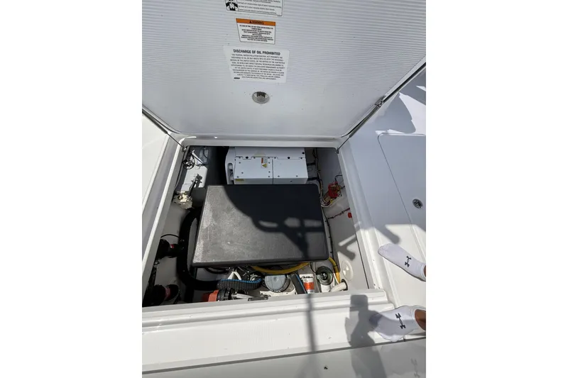 Slide: The Image of 2024 Bertram 39 CC engine compartment with visible components and safety instructions. - 43