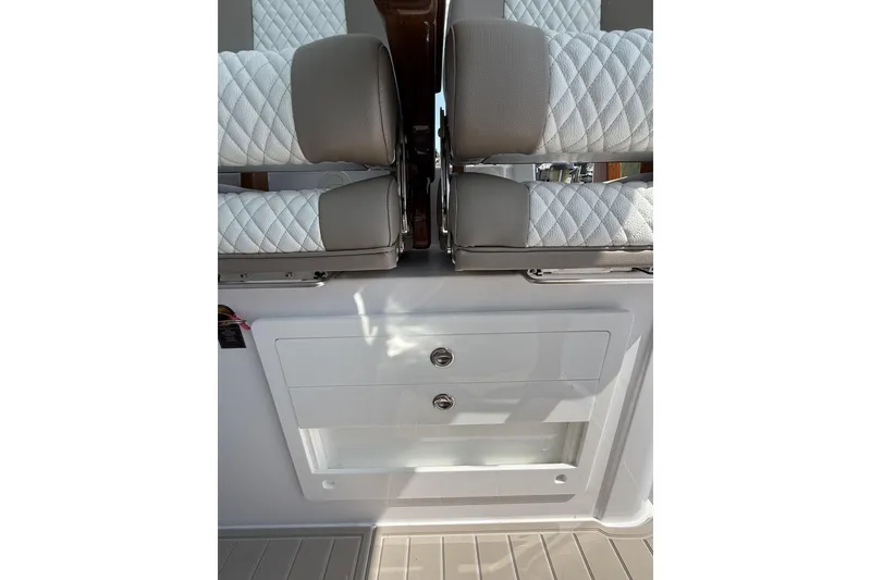 Slide: The Image of 2024 Bertram 39 CC boat interior with quilted seating and storage compartment. - 45