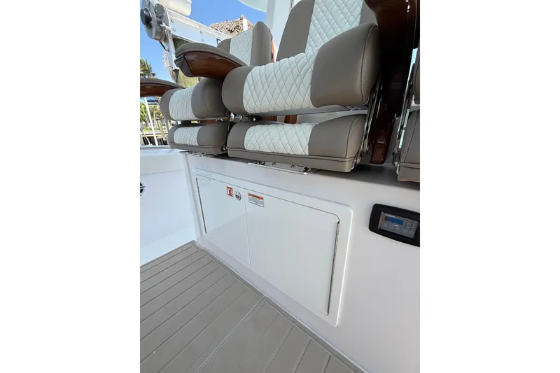 Slide: The Image of 2024 Bertram 39 CC boat interior with cushioned seating and control panel. - 46