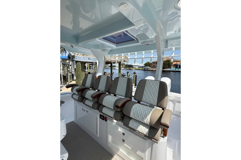 Slide: The Image of Interior of 2024 Bertram 39 CC boat with luxurious seating and waterfront view. - 48