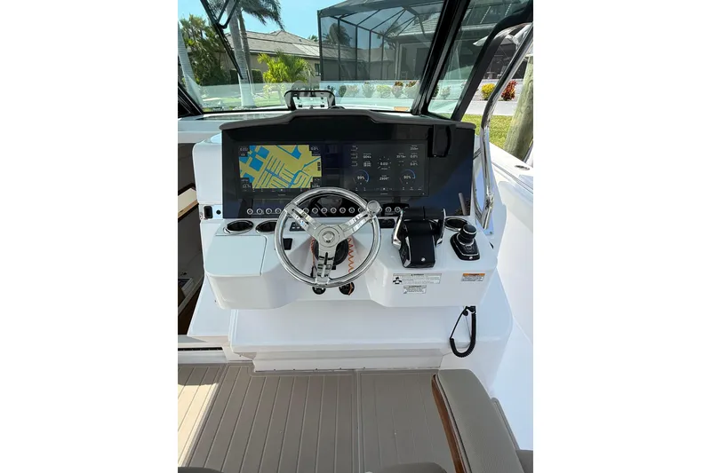 Slide: The Image of 2024 Bertram 39 CC boat helm with advanced navigation display and controls. - 49