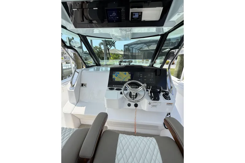 Slide: The Image of 2024 Bertram 39 CC boat cockpit with modern steering and navigation system. - 50