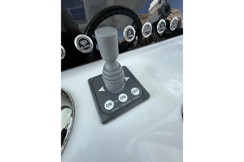 Slide: The Image of Control panel of 2024 Bertram 39 CC boat with joystick and buttons. - 52