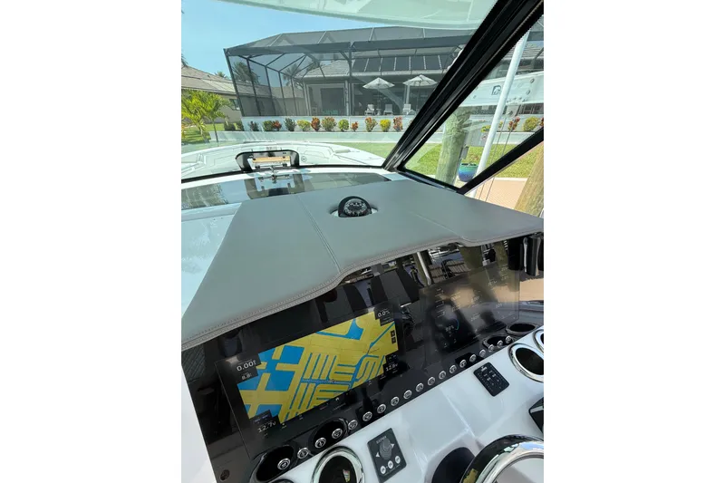 Slide: The Image of 2024 Bertram 39 CC boat dashboard with navigation display and controls. - 53