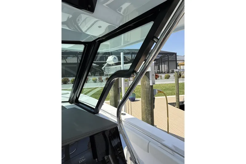 Slide: The Image of 2024 Bertram 39 CC boat interior with sleek window design and dock view. - 54