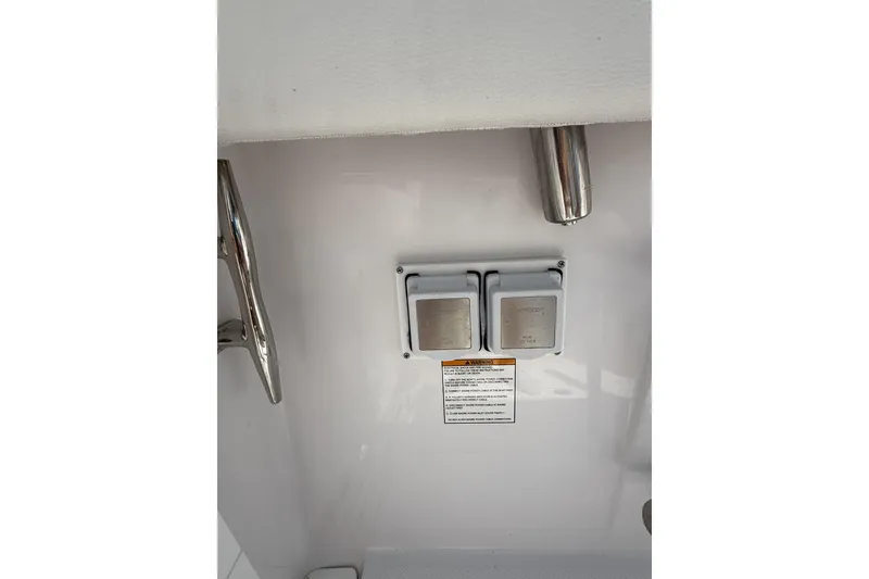 Slide: The Image of Electrical outlets on 2024 Bertram 39 CC boat with stainless steel fixtures. - 68