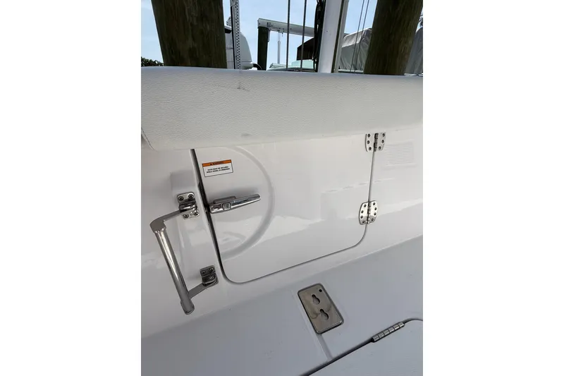 Slide: The Image of 2024 Bertram 39 CC boat interior with stainless steel hardware and white upholstery. - 69