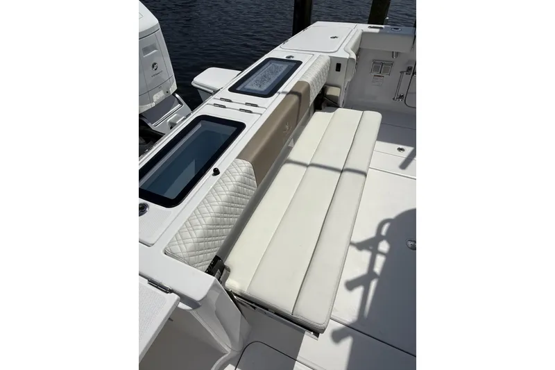 Slide: The Image of 2024 Bertram 39 CC boat interior with cushioned seating and storage compartments. - 70