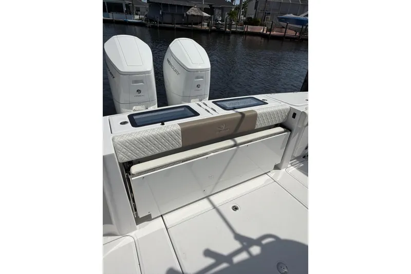 Slide: The Image of 2024 Bertram 39 CC boat with dual Mercury engines, featuring a cushioned seating area. - 71