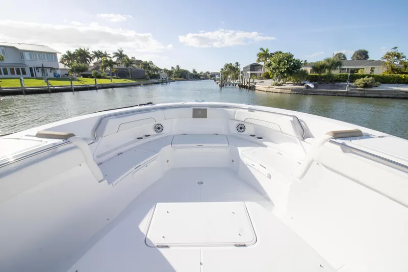 Slide: The Image of 2024 Bertram 39 CC boat interior with spacious seating on a sunny waterfront. - 72