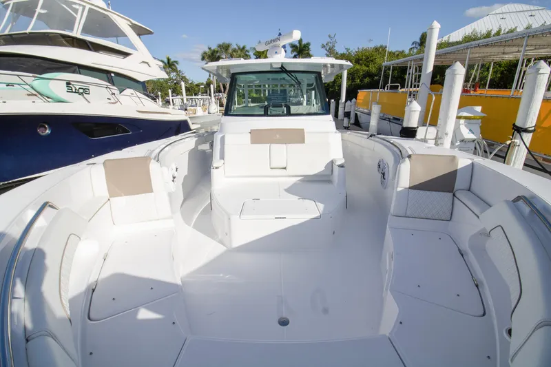Slide: The Image of 2024 Bertram 39 CC boat interior, spacious seating, docked at marina. - 73