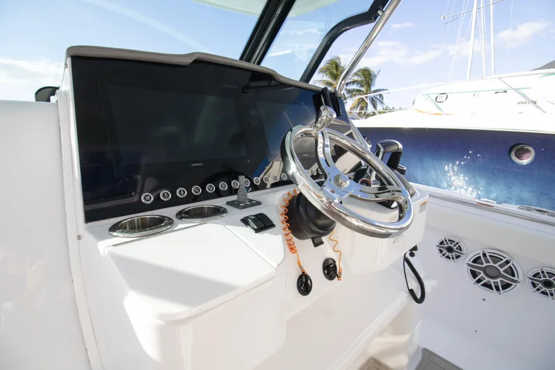 Slide: The Image of 2024 Bertram 39 CC helm with modern controls and sleek steering wheel. - 78