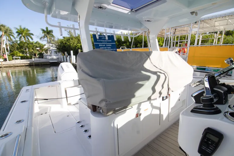 Slide: The Image of 2024 Bertram 39 CC boat interior with covered seating and control panel. - 80