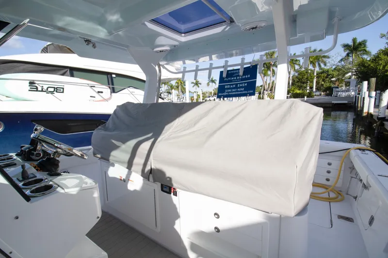 Slide: The Image of 2024 Bertram 39 CC boat interior with covered seating and steering wheel. - 81