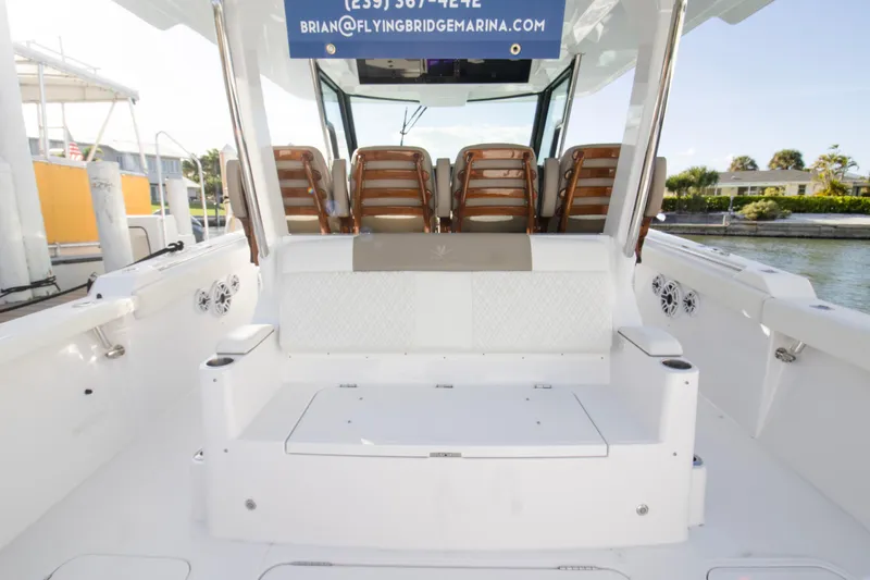Slide: The Image of 2024 Bertram 39 CC boat interior with seating and water view. - 84