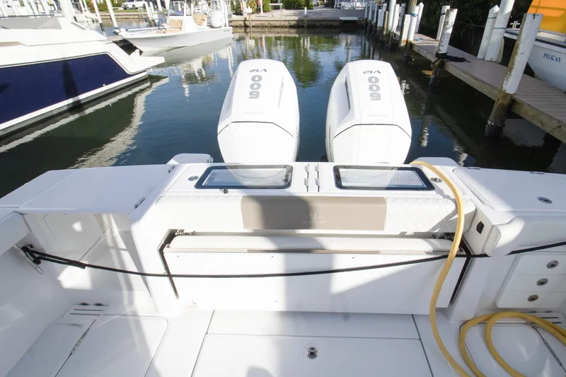 Slide: The Image of 2024 Bertram 39 CC boat with dual 600 HP outboard engines docked at marina. - 85