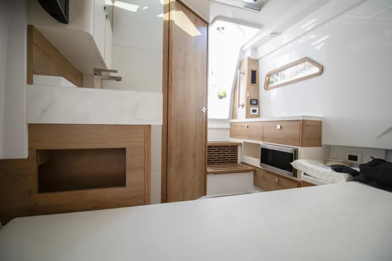 Slide: The Image of Luxurious interior of 2024 Bertram 39 CC boat with modern wood finishes. - 91