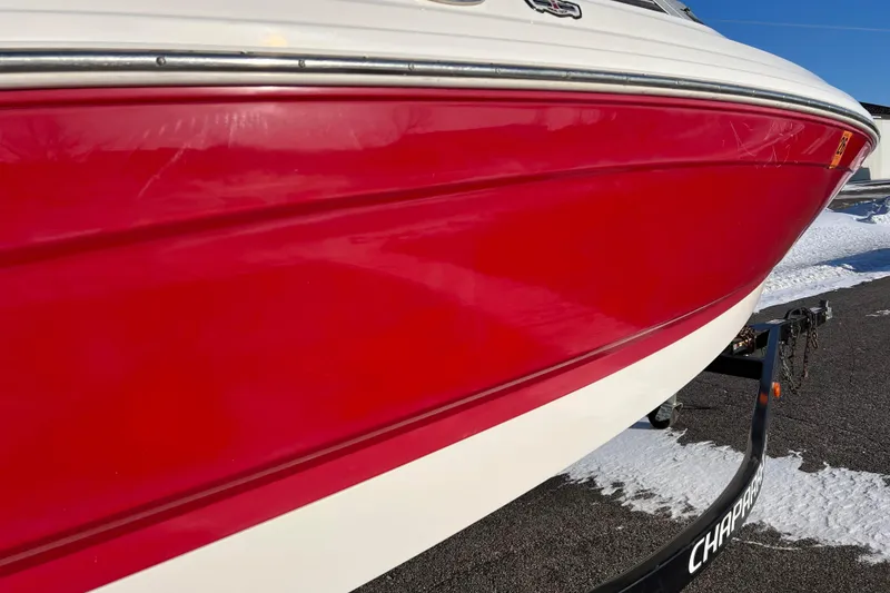 Slide: The Image of Red and white 2010 Chaparral 216 SSi boat on trailer in snowy setting. - 11