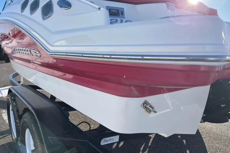 Slide: The Image of 2010 Chaparral 216 SSi boat on trailer, red and white exterior, sunny day. - 23