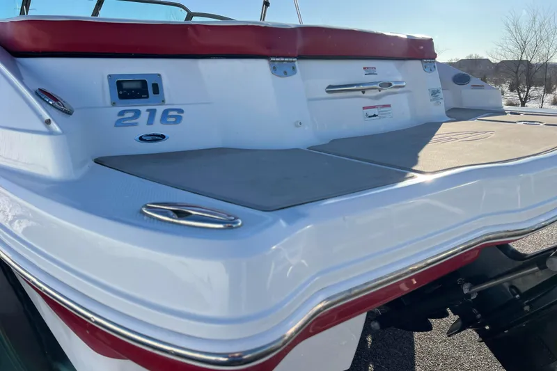 Slide: The Image of 2010 Chaparral 216 SSi boat stern with red trim and swim platform. - 25