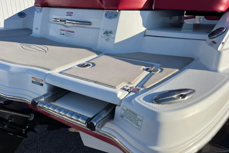 Slide: The Image of 2010 Chaparral 216 SSi boat swim platform with retractable ladder and red seating. - 26