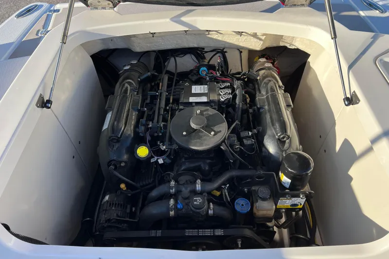 Slide: The Image of Engine compartment of a 2010 Chaparral 216 SSi boat, showcasing detailed components. - 30