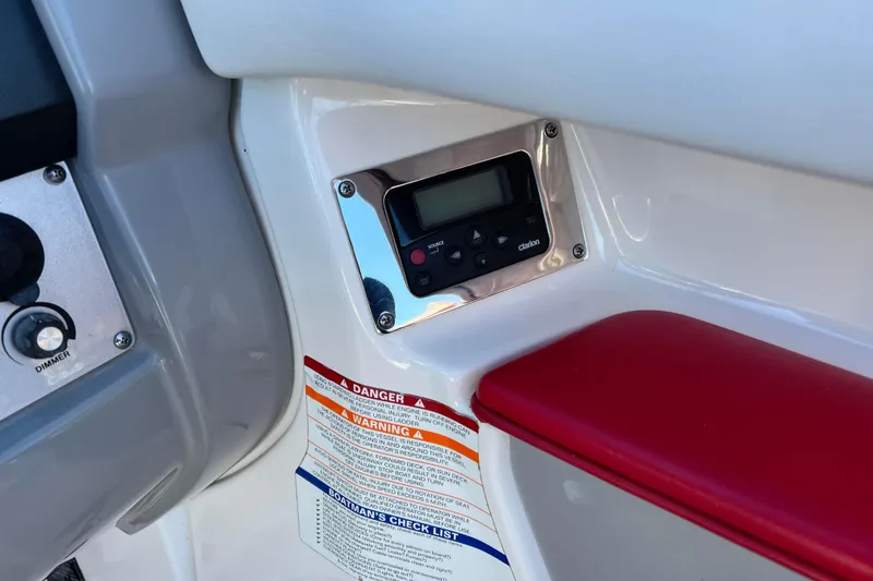 Slide: The Image of 2010 Chaparral 216 SSi boat dashboard with control panel and safety warnings. - 37