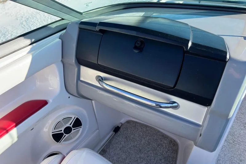Slide: The Image of 2010 Chaparral 216 SSi boat interior with glove compartment and speaker. - 42